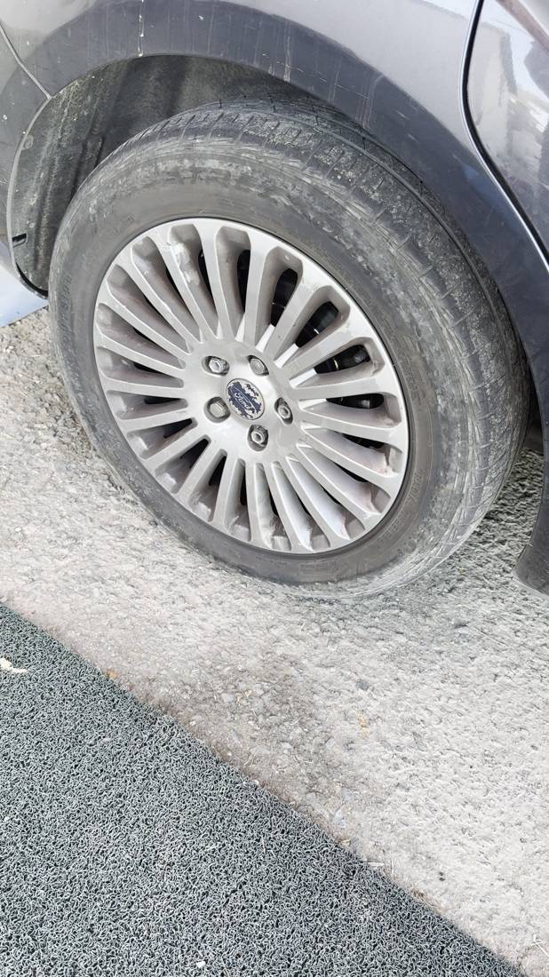 Ford wheel before cleaning, covered in road dust